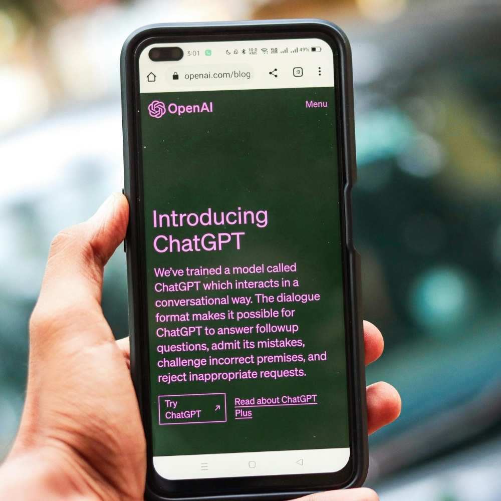 a Phone hold in a hand while connected with ChatGPT
