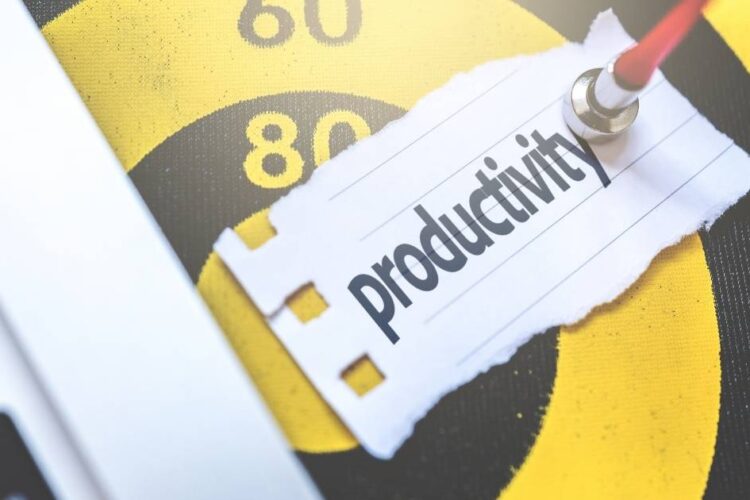 A yellow and black Target pointed by a dart with a piece of paper with written "Productivity"