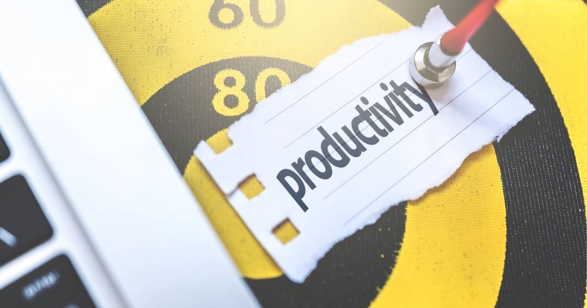 A yellow and black Target pointed by a dart with a piece of paper with written "Productivity"