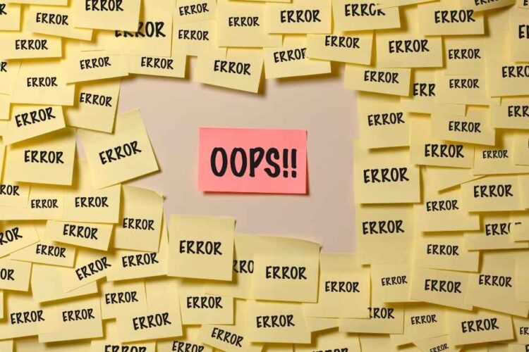 Wall full of yellow post-it with "error" written inside and one with written "OPS"