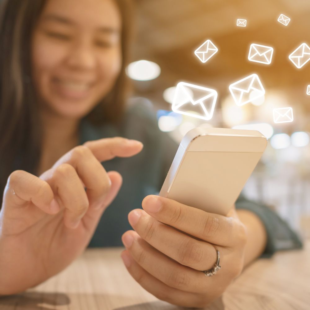 A lady sending and receiving messages and emails