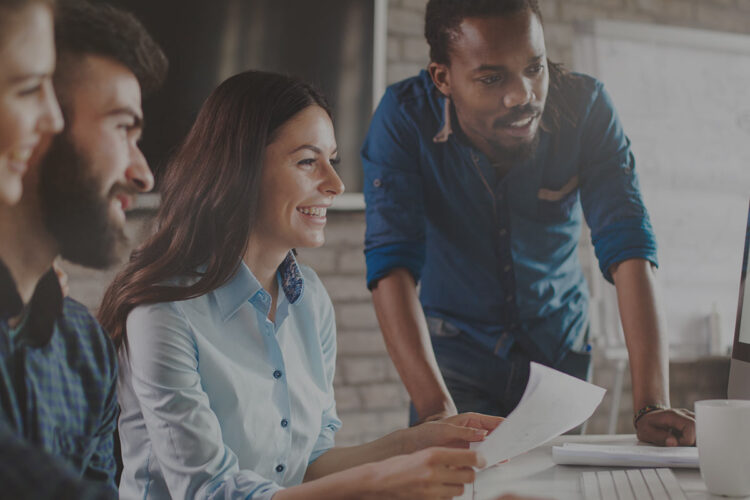 Group of Entrepreneurs guided by a teacher while watching a screen studying AI