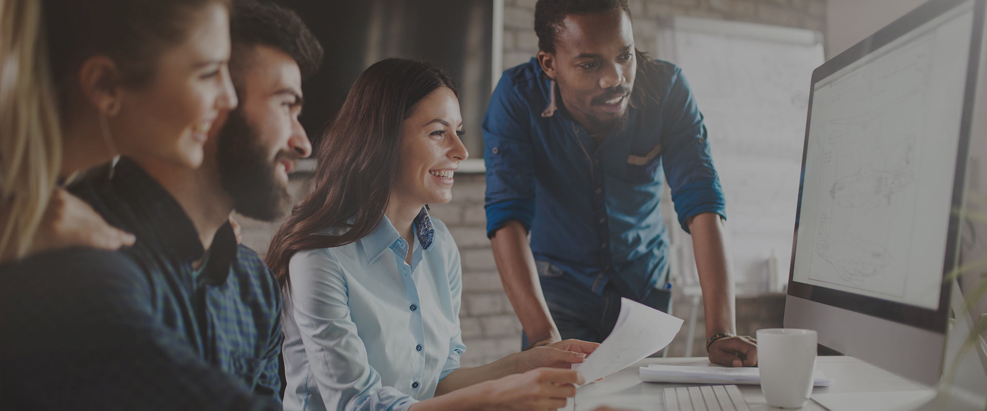 Group of Entrepreneurs guided by a teacher while watching a screen studying AI